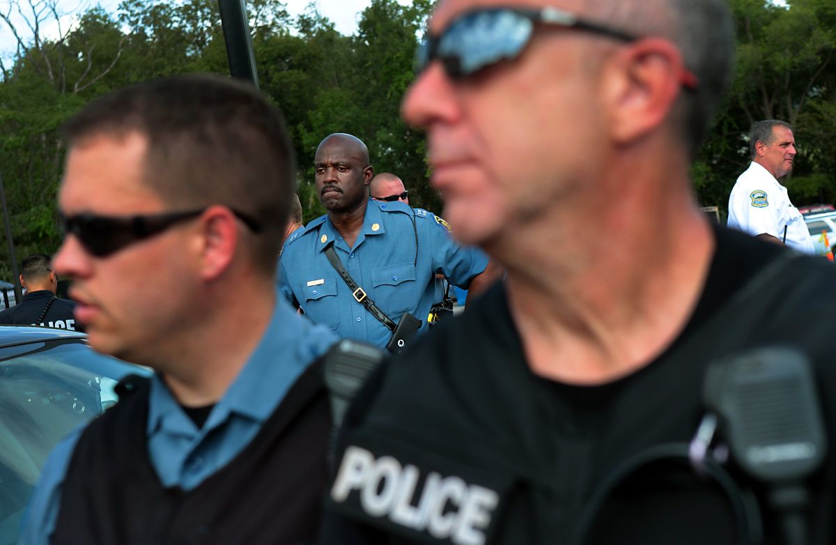 Protesters rally in front of Ferguson police station